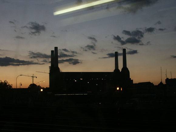 A power station, we think it is Battersea from the south taken from the train, you can see a reflection of the lights in the window